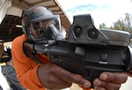 Staff Sgt. Eric Brown of the Florida National Guard's Counterdrug Training Academy practices with his weapon before competition at the 2008 SWAT Round-up International Competition in Orlando, Fla., Dec. 4.