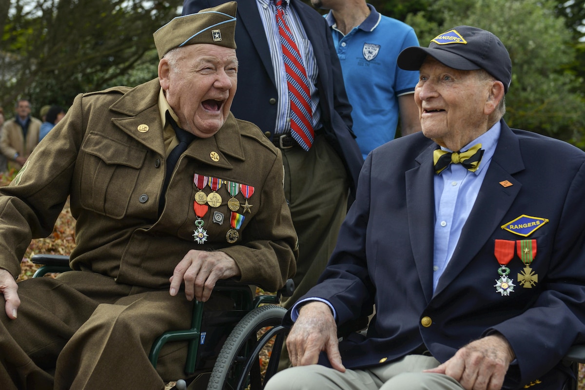 Two D-Day veterans who participated in the liberation of France share a laugh in Saint-Laurent-sur-Mer, France, June 5, 2017, while attending a ceremony to commemorate the 73rd anniversary of D-Day. DOD photo by Airman 1st Class Alexis C. Schultz