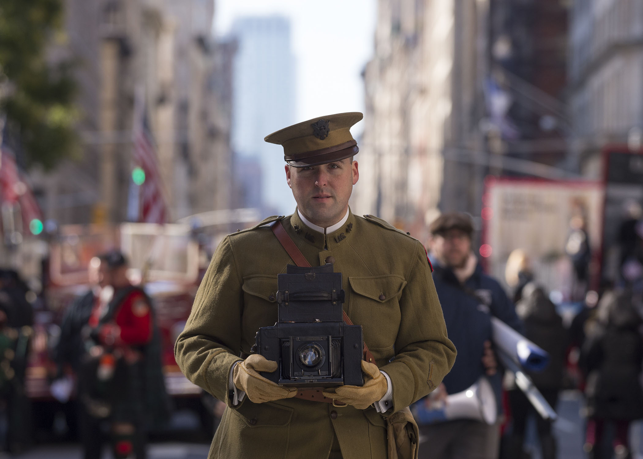 Person in hisortic uniform holding a vintage camera