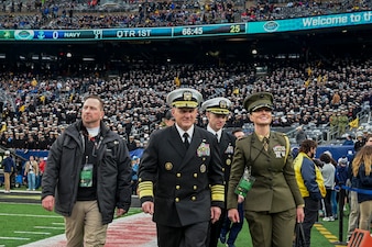EAST RUTHERFORD, N.J. (Dec. 11, 2021) Chief of Naval Operations (CNO) Adm. Mike Gilday, center, walks on the sideline before the 122nd Army-Navy Football Game. (U.S. Navy photo by Mass Communication Specialist 1st Class Sean Castellano/Released)