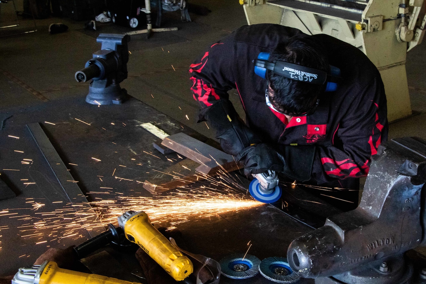 Steelworker Constructionman Alexander Rose grinds out a metal strip in preparation for welding on Naval Amphibious Base Coronado, Feb. 2, 2021.