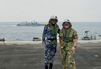 BAY OF BENGAL (Oct. 14, 2021) Chief of Naval Operations Adm. Mike Gilday poses for a photo  with Indian Chief of Naval Staff Adm. Karambir Singh on the flight deck of the USS Carl Vinson (CVN 70) during Exercise Malabar. MALABAR is a maritime exercise designed to improve integration, address common maritime security priorities and concerns, enhance interoperability and communication, and strengthen enduring relationships between the Royal Australian Navy, Royal Indian Navy, Japan Maritime Self-Defense Force, and U.S. maritime forces. (U.S. Navy photo by Cmdr. Nate Christensen/Released)