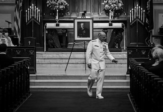 Chief of Naval Operations (CNO) Adm. Mike Gilday returns to his seat after speaking at a memorial service for the 23rd CNO, Adm. Carlisle Trost, at the U.S. Naval Academy. Trost was the CNO from 1986 to 1990. (U.S. Navy photo by Mass Communication Specialist 1st Class Sean Castellano/Released)