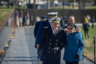WASHINGTON (Mar. 29, 2022) Chief of Naval Operations Adm. Mike Gilday, left, speaks to Mrs. Ann Smith after a wreath laying at the Vietnam Veterans Memorial on National Vietnam War Veterans Day. Anne Smith is the widow of Lt. Cmdr. James A. Smith, who was killed in action aboard the USS Oriskany during the Vietnam War. (U.S. Navy photo by Mass Communication Specialist 1st Class Sean Castellano/Released)