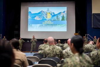 Navy Personnel Command’s Force Master Chief William Houlihan speaks to Sailors during a Town Hall meeting
