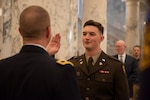 Brig. Gen. Ryan Robinson administers the oath of commissioning to his son, 2nd Lt. Benjamin Robinson, Dec. 15, 2023, at the Idaho State Capitol in Boise. Robinson commissioned in the same location in May 1996.