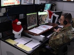 Airman 1st Class Kyle Larsen, a member of the New York Air National Guard assigned to the Eastern Air Defense Sector in Rome, New York, keeps an eye on the sky over the eastern United States while preparing for Christmas Eve, when the sector’s Airmen will help in the annual NORAD Tracks Santa effort.