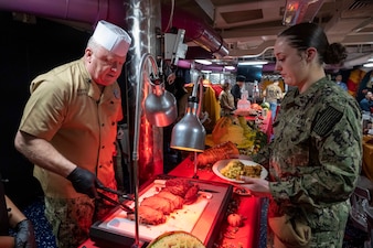 YOKOSUKA, Japan (Nov. 23, 2023) – Master Chief Petty Officer of the Navy James Honea serves Thanksgiving dinner to Sailors aboard the U.S. Navy's only forward-deployed aircraft carrier USS Ronald Reagan (CVN 76), Nov. 23. Chief of Naval Operations Adm. Lisa Franchetti and Honea visited Reagan and other 7th Fleet commands to engage with Sailors and Navy leadership to highlight Franchetti's priority of strengthening the Navy team. (U.S. Navy photo by Chief Mass Communication Specialist Amanda R. Gray)