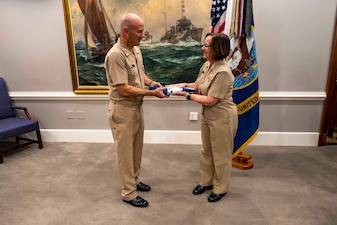 WASHINGTON (Jan. 5, 2024) - Chief of Naval Operations Adm. Lisa Franchetti presents Adm. James Kilby with the Vice Chief of Naval Operations (VCNO) flag during an assumption of office ceremony held at the Pentagon, Jan. 5. Kilby assumed the duties and responsibilities as the 43rd VCNO during the ceremony. (U.S. Navy photo by Chief Mass Communication Specialist Amanda R. Gray)