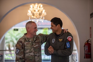 U.S. Air Force Col. Barton Kenerson, Combined Joint Task Force – Resolute Sentinel 2024 commander, left, and Peruvian Air Force Col. Fidel Castro, CJTF – RS24 deputy commander, chat before a commander update briefing at task force headquarters in Lima, Peru, May 30, 2024. The Resolute Sentinel exercise honors the promise to be trusted partners in the region by increasing collaboration, enhancing interoperability and building partner nation capacity to work together when support is needed. (U.S. Air Force photo by Andrea Jenkins)