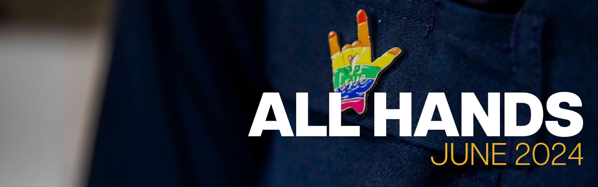 Dark hues of navy colors background with white font titled all hands with gold font reads june 2024. American Sign Language I love you is colored by stripes of rainbow in between all and hands.