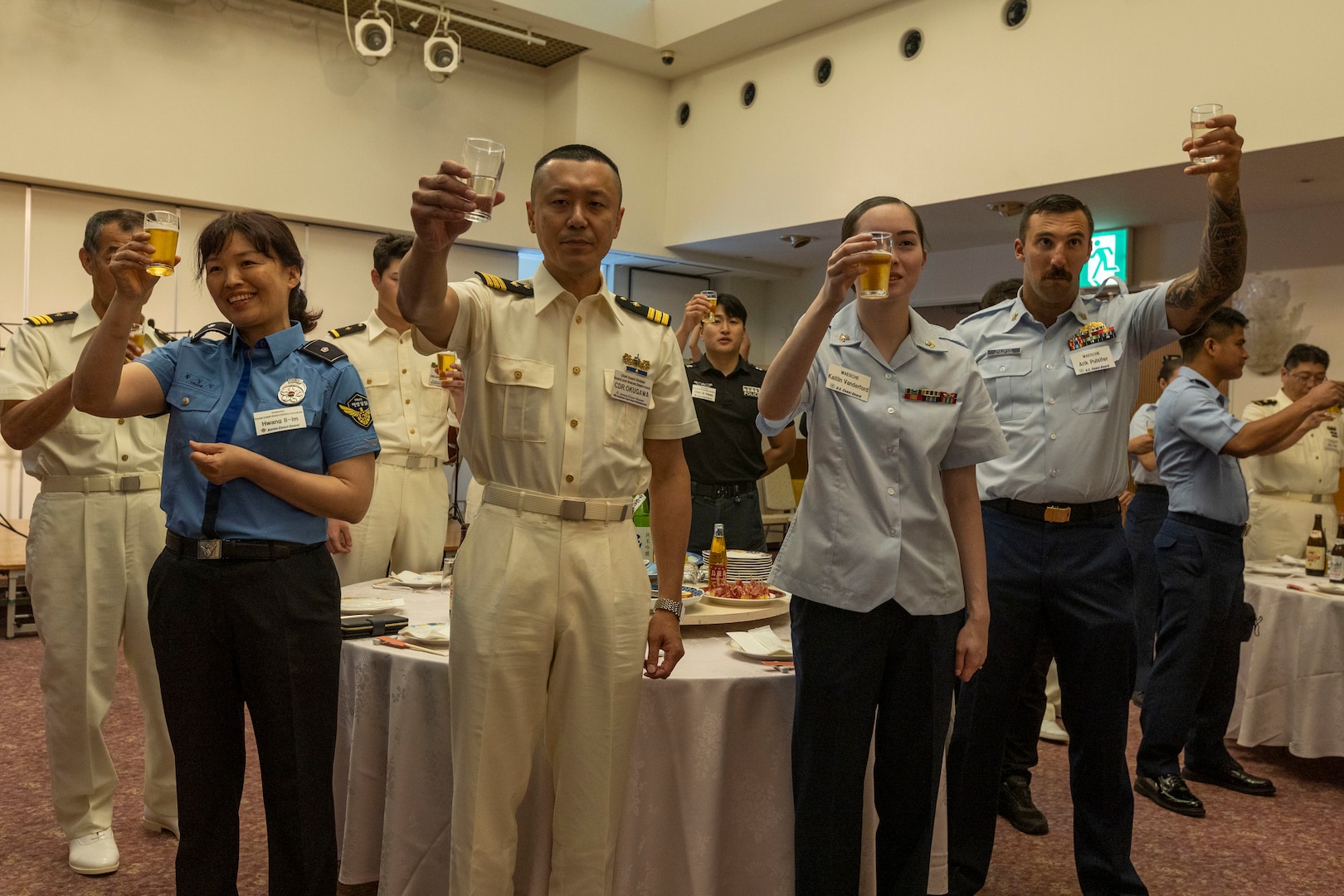 Members of the United States, Japanese, and Republic of Korea Coast Guards raise a toast during a reception ceremony in Maizuru, Japan, June 5, 2024. The reception was held to commemorate the first trilateral training between the United States, Japanese and Republic of Korea Coast Guards. The U.S. Coast Guard has operated in the Indo-Pacific for more than 150 years, and the service is increasing efforts through targeted patrols with our National Security Cutters, Fast Response Cutters and other activities in support of Coast Guard missions to enhance our partnership. (U.S. Marine Corps photo by Cpl. Elijah Murphy)