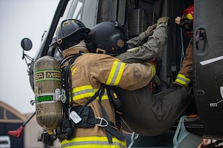 U.S. Air Force firefighters simulate evacuating a pilot for a fire rescue evacuation training during Resolute Sentinel 2024 in Lima, Peru, June 3, 2024. RS24 is a multinational training opportunity that improves the readiness of U.S. and partner nation militaries through humanitarian assistance and disaster response. (U.S. Air force photo by Airman 1st Class Sir Wyrick)