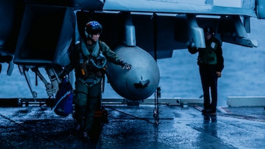 Lt. Rachel Lee, attached to Electronic Attack Squadron (VAQ) 140 as an electronic warfare officer, from Centerville, Virginia, performs preflight checks on an E/A-18G Growler on the flight deck of Nimitz-class aircraft carrier USS George Washington (CVN 73) in the Pacific Ocean, June 7, 2024.