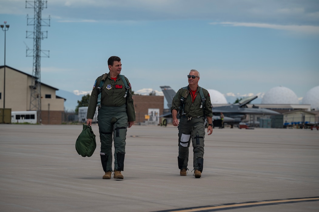 U.S. Air Force Lt. Gen. Michael A. Loh, left, director, Air National Guard, and Col. Jeremiah Tucker, commander, 140th Wing, Colorado National Guard, walk on the flight line.