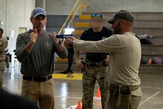 A photo of a man teaching a pistol class.