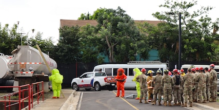 A photo of people training in hazmat suits.