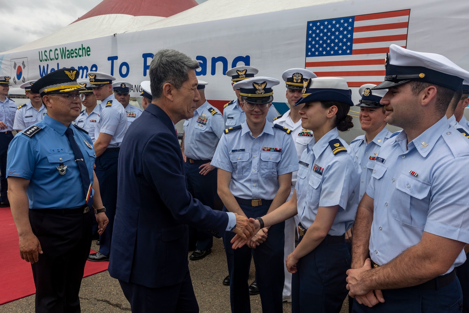 Lee Kang-Deok, the mayor of Pohang, Republic of Korea, shakes hands with U.S. Coast Guardsmen during a welcoming reception in Pohang, Republic of Korea, June 9, 2024. The Waesche’s arrival marked the first visit by a U.S. Coast Guard ship to Pohang, which was marked with an opening ceremony between United States and Korea Coast Guardsmen. 7th Fleet’s principal surface force. U.S. Coast Guard missions in the Indo-Pacific focus on issues directly supporting and advancing our regional partners’ efforts to protect fish stocks, ensure safety of life at sea, support environmental response, and provide disaster relief. (U.S. Marine Corps photo by Cpl. Elijah Murphy)