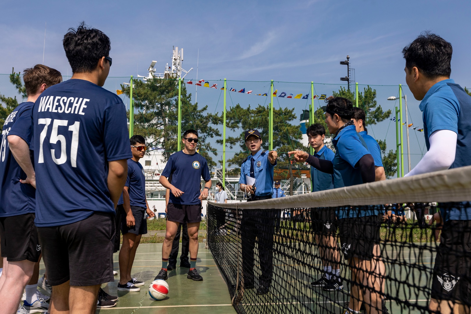 A member of the Korea Coast Guard explains the rules of jokgu to members of the U.S. Coast Guard assigned to the U.S. Coast Guard Cutter Waesche (WMSL-751) before a match during a sports day in Pohang, Republic of Korea, June 10, 2024. Korea Coast Guardsmen explained the rules and demonstrated how to play jokgu to United States Coast Guardsmen before participating in a friendly competition. Waesche is the second U.S. Coast Guard National Security Cutter deployed to the Indo-Pacific in 2024. Coast Guard cutters routinely deploy to the region to engage with partner nations to ensure a free and open Indo-Pacific. (U.S. Marine Corps photo by Cpl. Elijah Murphy)
