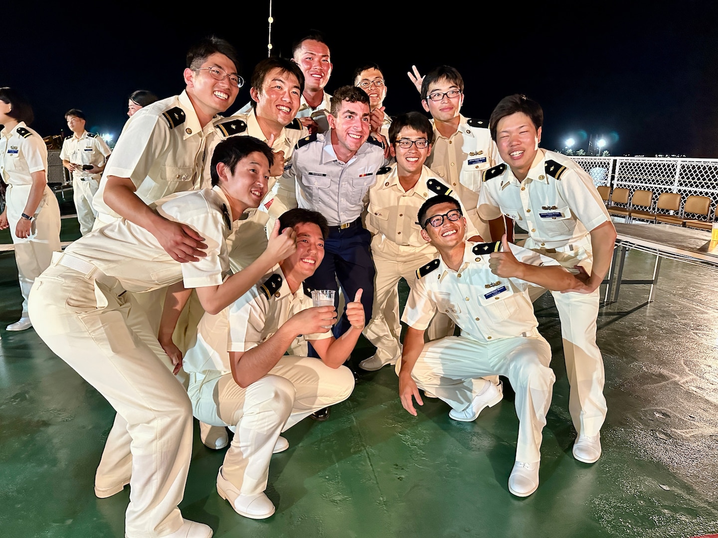 U.S. Coast Guard Cadet Allentuck takes a moment for a photo with cadets aboard the Japanese Coast Guard training ship Kojima during their visit to Guam on June 12, 2024. During the visit, three U.S. Coast Guard Academy cadets had the unique opportunity to share their recent experience of joining their Japanese counterparts on the voyage to Guam. This journey created lasting memories and built strong professional relationships. (U.S. Coast Guard photo by Chief Warrant Officer Sara Muir)