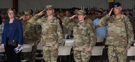 A photo of service members saluting.