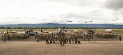 A photo of service members posing for a photo.