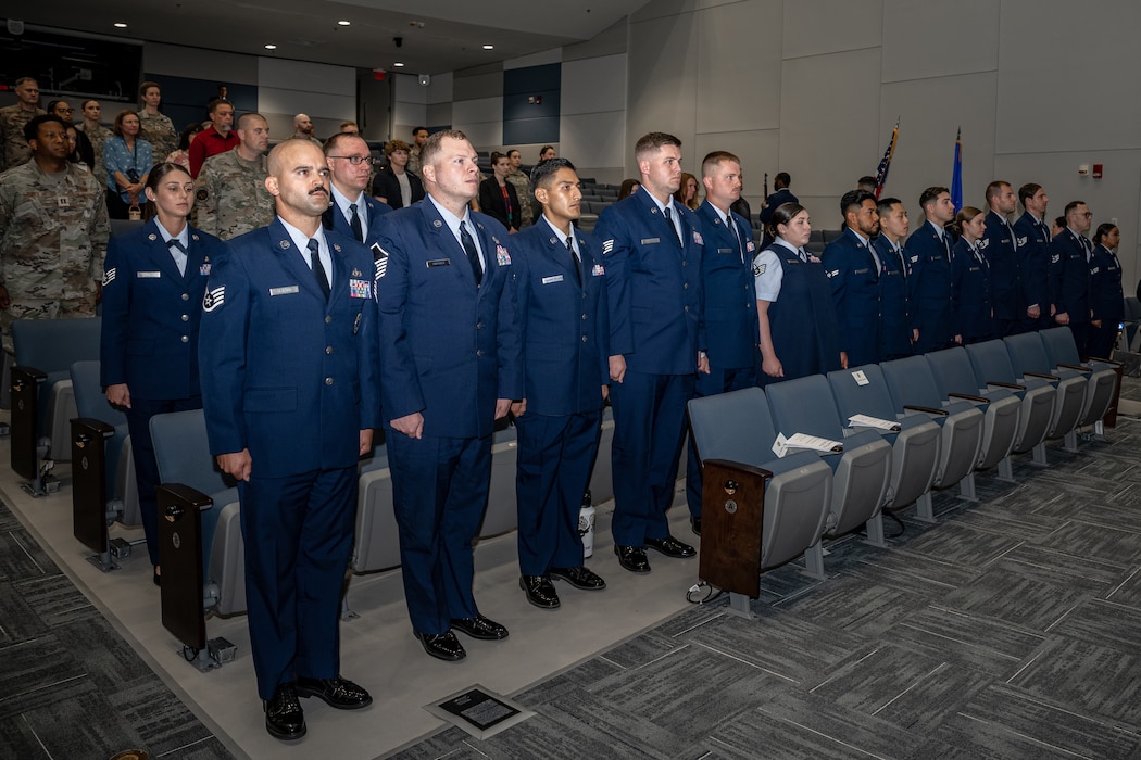 A group of Airmen stand at attention during a ceremony