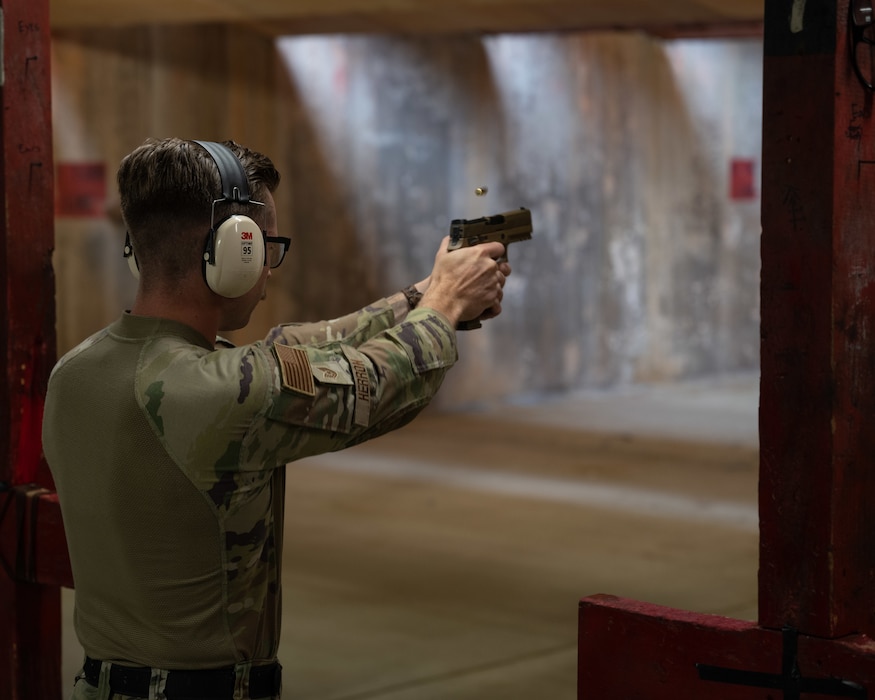 U.S. Air Force Tech Sgt. Jeffery Herron, 8th Security Forces Squadron flight chief, fires a Sig Sauer M18