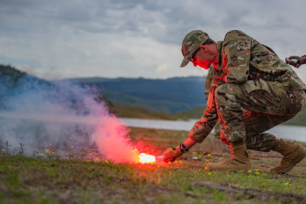 Maj. Nicholas Kroll, a medical specialist assigned to the 124th Medical Group, Idaho National Guard, lights a flare