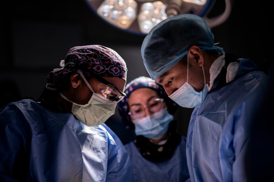 U.S. Air Force Lt. Col. Kim Broughton, 96th Surgical Squadron orthopedic surgeon, conducts surgery on a leg alongside Peruvian surgeons
