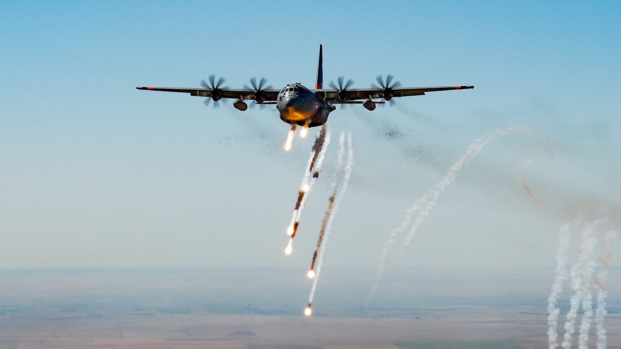 A C-130H Hercules from the 302nd Airlift Wing expends chaff and flares