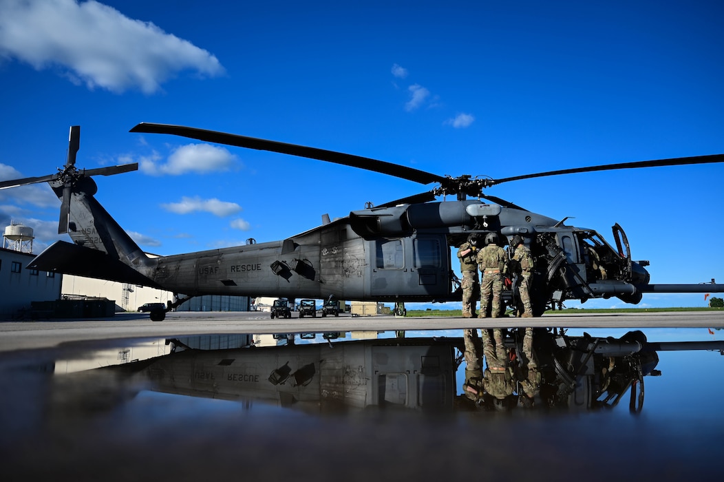 U.S. Air Force Airmen assigned to the 56th Rescue Squadron discuss preflight logistics a