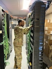 Staff Sgt. DeAnthony Norales of the 212th Engineering Installation Squadron, Otis Air National Guard Base, Mass., reroutes network cabling after upgrading the switches in the rack. Airmen peformed network infrastructure upgrades at Joint Base Langley-Eustis in May 2024.