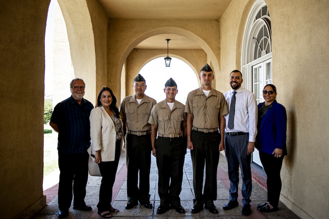 U.S. Marines with Echo Company, 2nd Recruit Training Battalion, pose for a photo with their sponsors after a naturalization ceremony at Marine Corps Recruit Depot, San Diego, June 27, 2024. The naturalization ceremony took place during family day to recognize Marines who became United States citizens by completing bootcamp. (U.S. Marine Corps photo by Sgt. Yvonna Guyette)