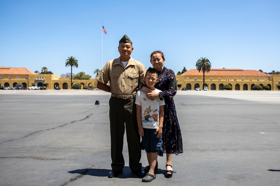 U.S. Marine Corps Pfc. Jiang Xinnian, a native of China and recruited from Pasadena, Calif. with Echo Company, 2nd Recruit Training Battalion, poses for a photo with his family after a naturalization ceremony at Marine Corps Recruit Depot, San Diego, June 27, 2024. The naturalization ceremony took place during family day to recognize Marines who became United States citizens by completing bootcamp. (U.S. Marine Corps photo by Sgt. Yvonna Guyette)