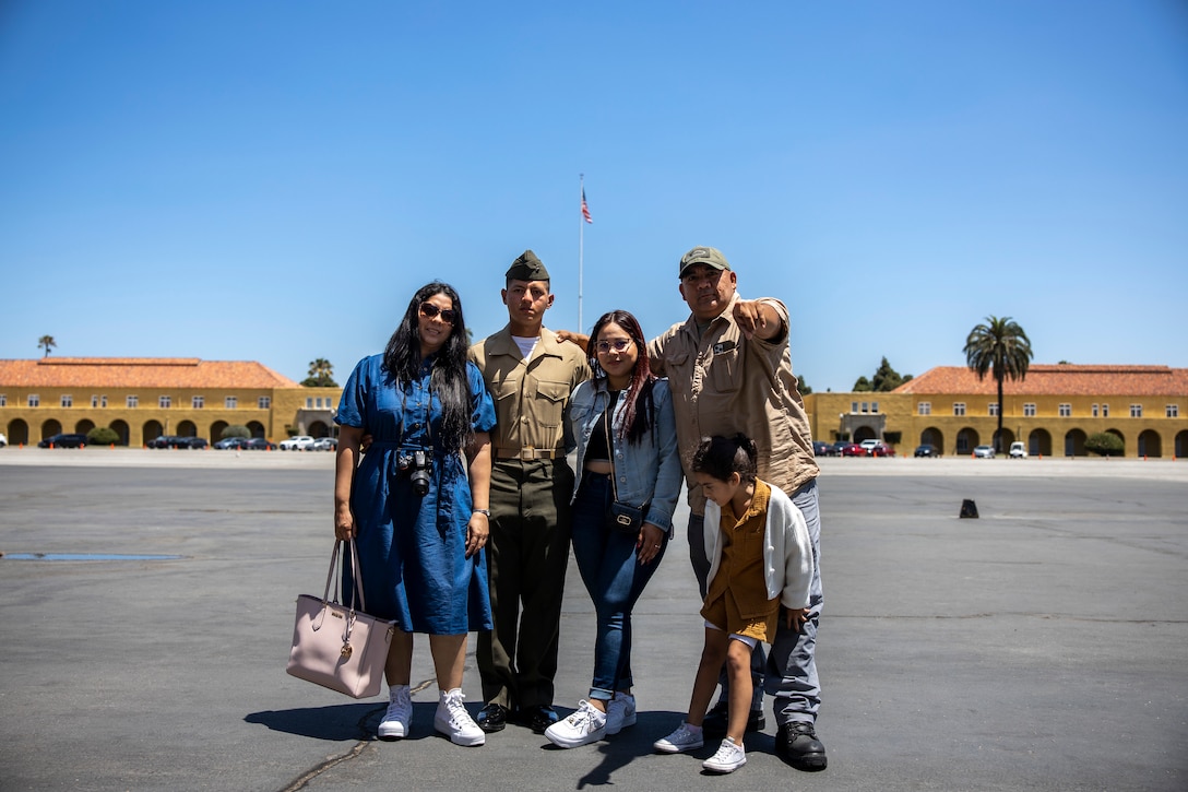 U.S. Marine Corps Pfc. Cristian Martinezescobar, a native of El Salvador and recruited from Fonana, Calif. with Echo Company, 2nd Recruit Training Battalion, poses for a photo with his family after a naturalization ceremony at Marine Corps Recruit Depot, San Diego, June 27, 2024. The naturalization ceremony took place during family day to recognize Marines who became United States citizens by completing bootcamp. (U.S. Marine Corps photo by Sgt. Yvonna Guyette)