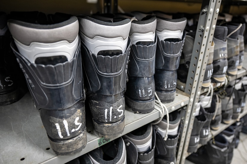 Several insulated boots sit on a shelf.
